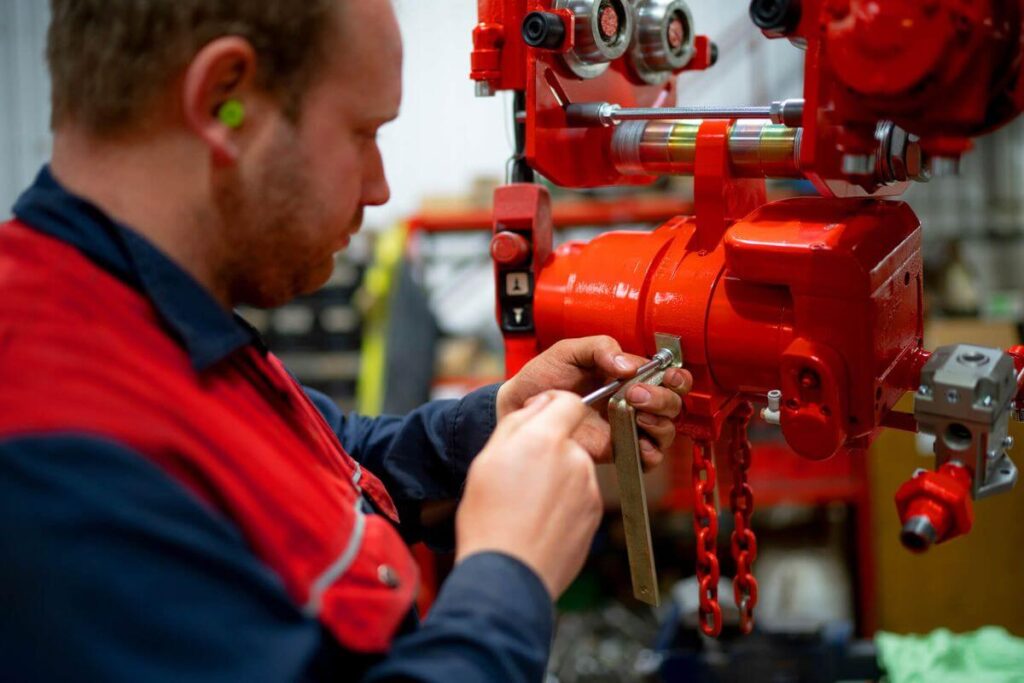 A Red Rooster Lifting Engineer repairing an Air Hoist