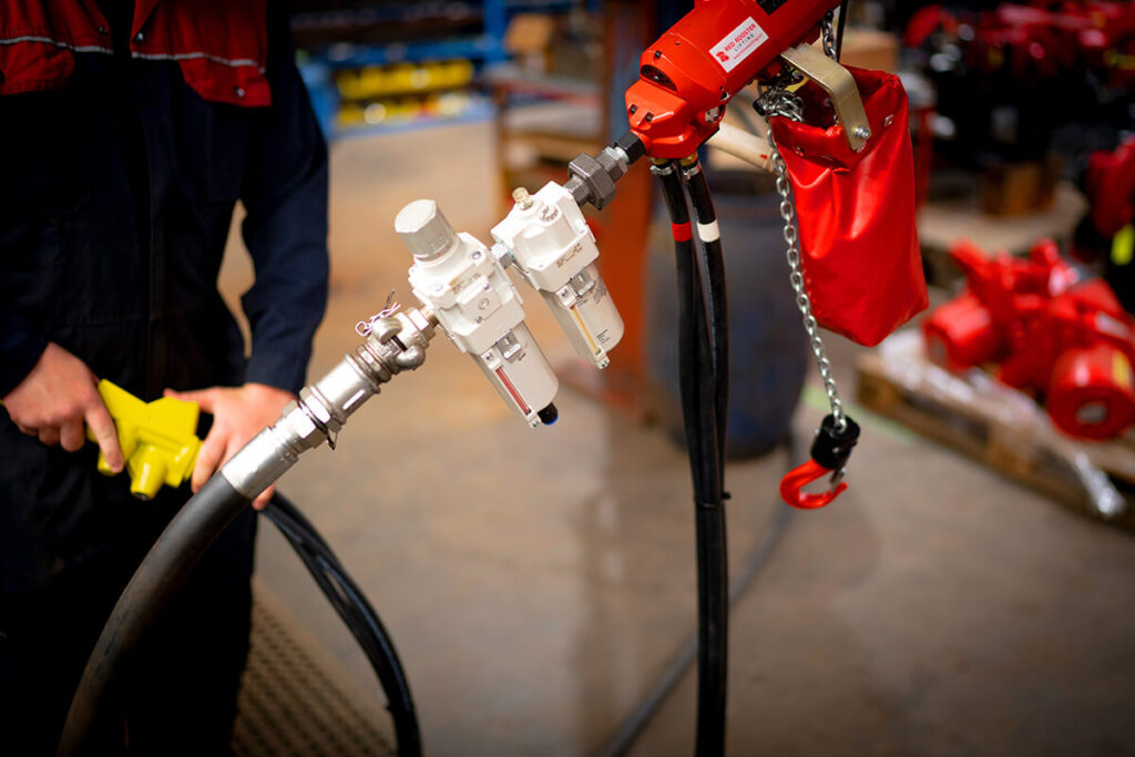 An air pressure valve attached to an air hoist.