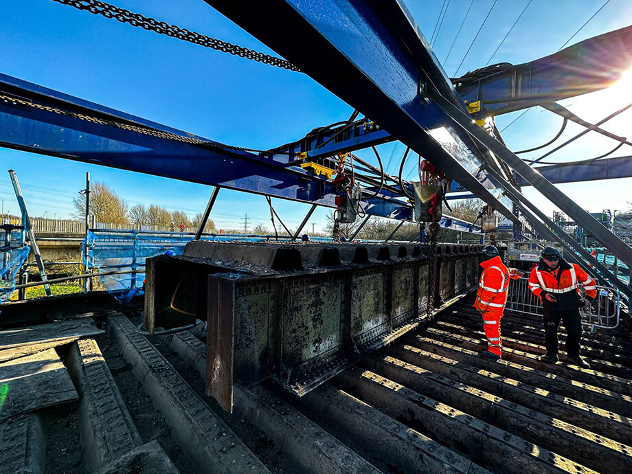 Air hoists supporting bridge beam removal during large-scale construction deconstruction project
